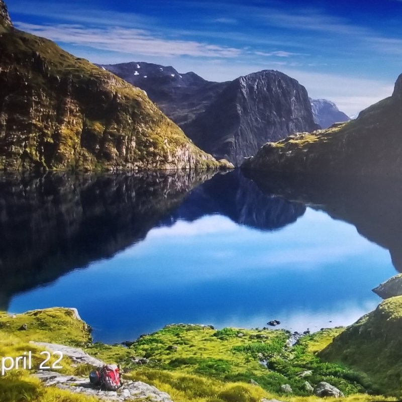 A lake and surrounding mountains