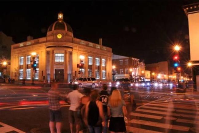 Georgetown at night with blurred people and cars