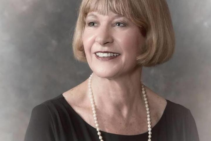 A portrait of a woman in pearls