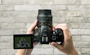 a hand holding a camera