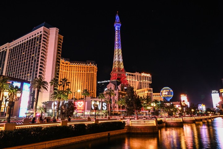 Night view of Las Vegas Strip with the Eiffel Tower replica and bright city lights.