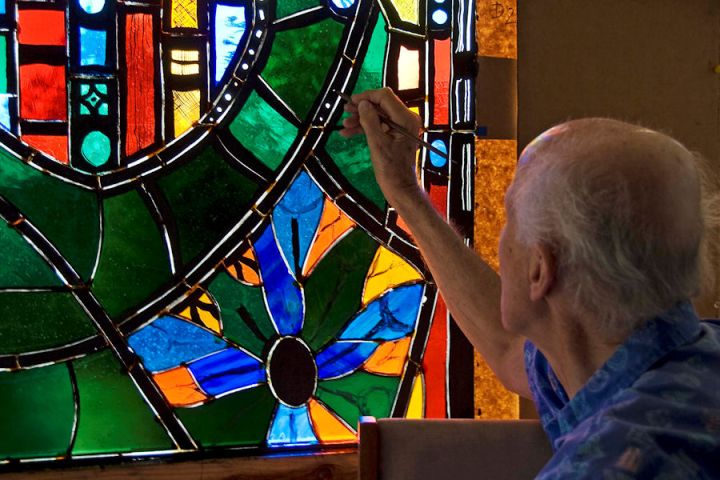 Rowan LeCompte working on a Stained-glass window