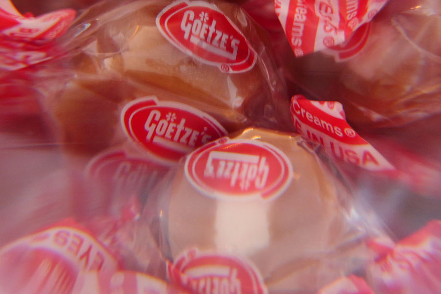 Close-up of Goetze's caramel creams ibehind a glass globe filled with water